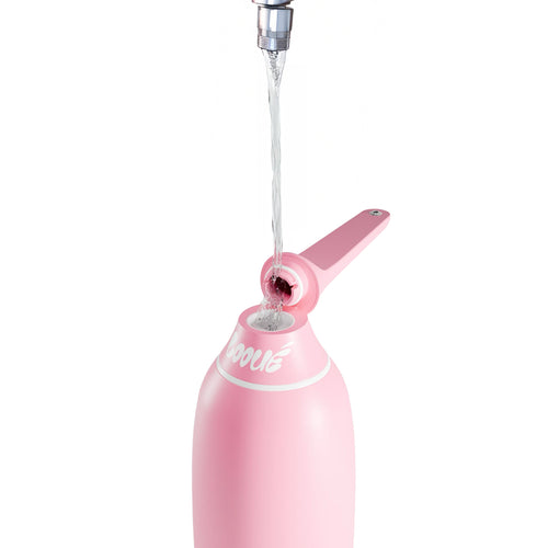Pink peri bottle with water being dispensed on a white background